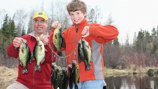 Farther and son with a stringer of crappies