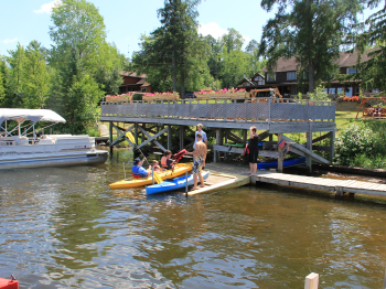 Pehrson Lodge dock staff help guests launch kayaks