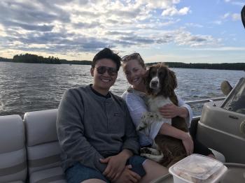 A group enjoys a pontoon cruise with their pup