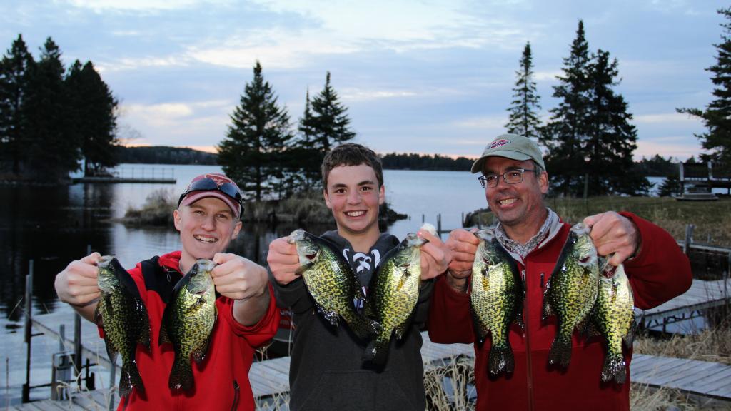 Group of family members each holding two crappie on Lake Vermilion.