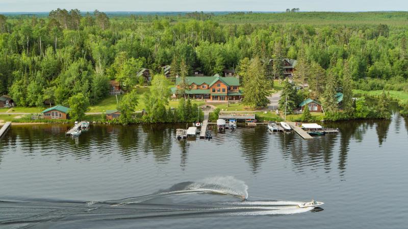 Overhead shot of Pehrson Lodge on Lake Vermilion with waterskier going by