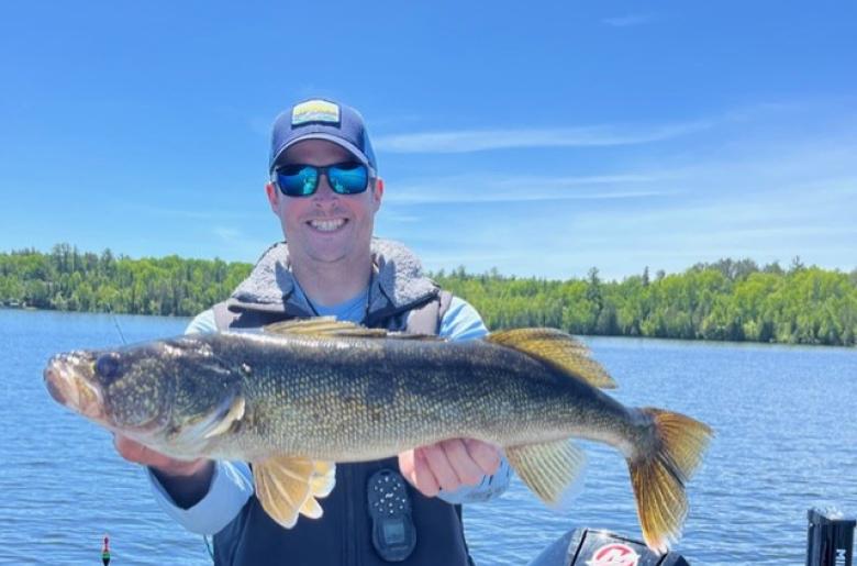 Guide Jason Freed smiling with a large Lake Vermilion walleye