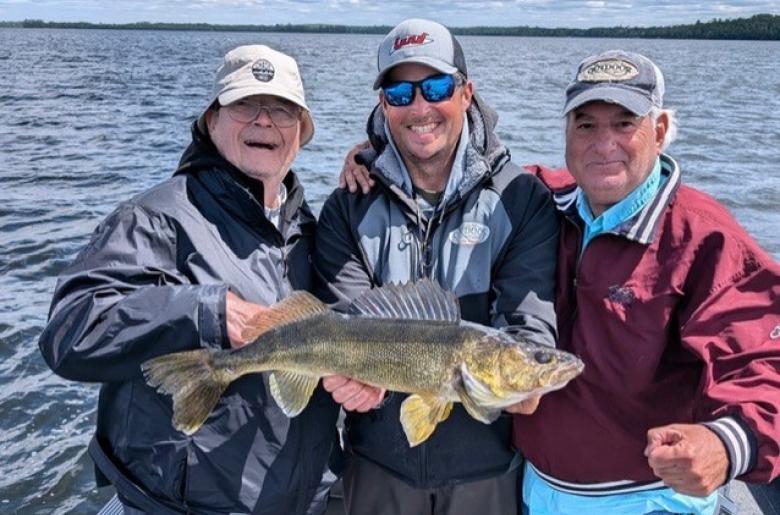 Guide Jason Freed and a couple of clients with a Lake Vermilion walleye