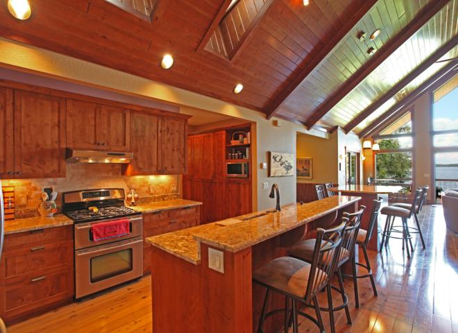 Kitchen with refrigerator, stove, dishwasher, and seating for eight.