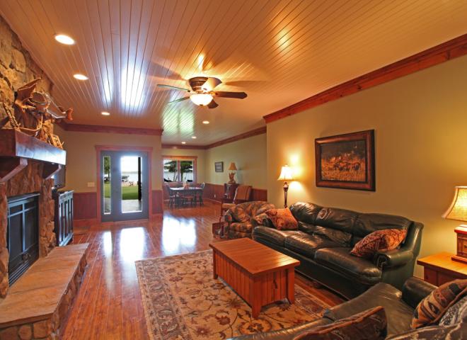 Downstairs living room with plenty of seating, game area, two futons, and gas fireplace.