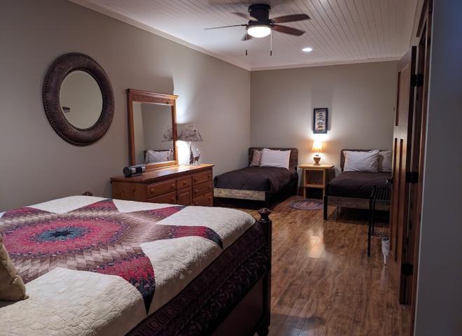 Downstairs bedroom with queen, two twins, and ensuite bathroom.