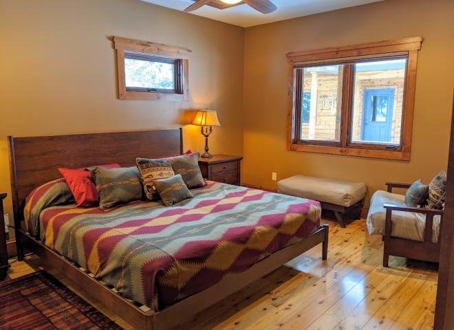 Main floor master bedroom with king bed, XL twin futon, and ensuite bathroom.