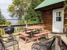 Deck area with picnic table, charcoal grill, and views of the lake.