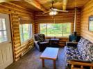 Living room with futon, chair and views of the lake.