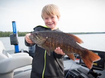 Young fisherman shows off a nice bass