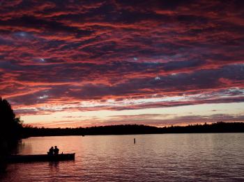 Couple on the dock enjoys a Lake Vermilion sunset