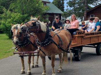 A family begins their horse-drawn wagon ride at Pehrson Lodge