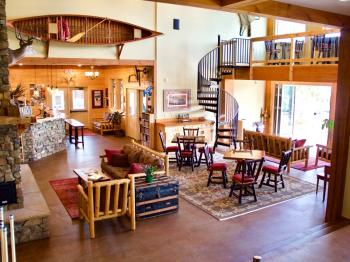 Lodge seating area with gas fireplace, 2 story views, and coffee bar.