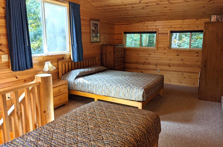 Upstairs bedroom with a queen, twin, and ensuite bathroom.