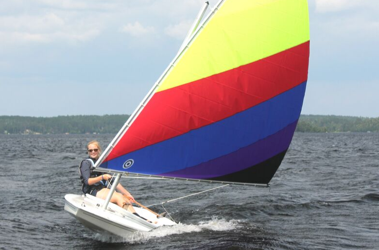 woman on sunfish sailboat