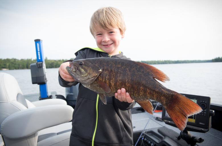Young fisherman shows off a nice bass