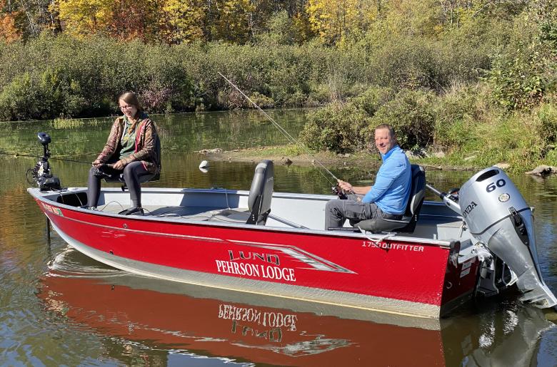 Trolling down the shoreline with a Lund fishing boat.