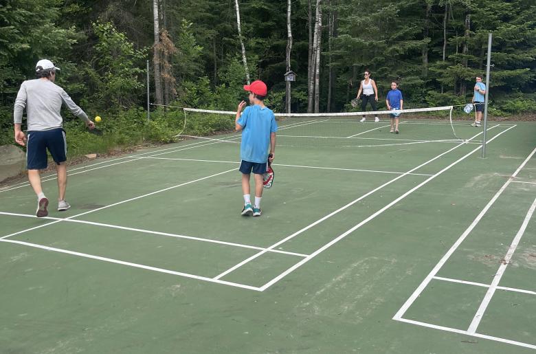 Family playing pickleball.