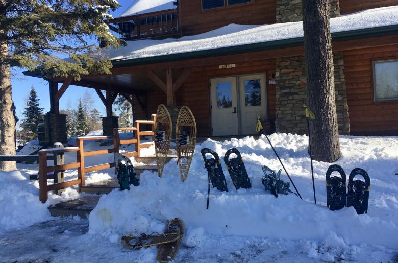 Lodge entrance in winter, with snow shoes stored in the snowbanks
