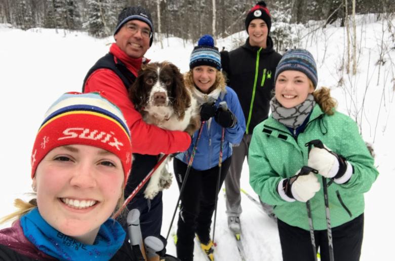 The Hanson family cross-country skiing during winter at Pehrson Lodge
