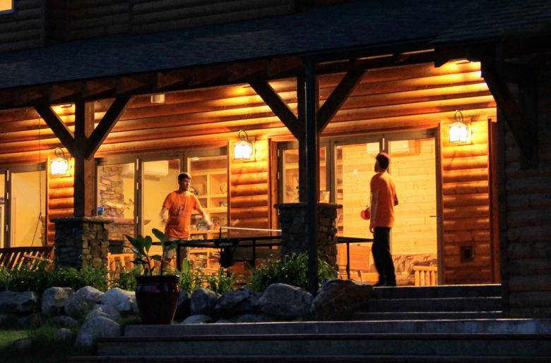 Friends enjoy ping pong at the Lodge