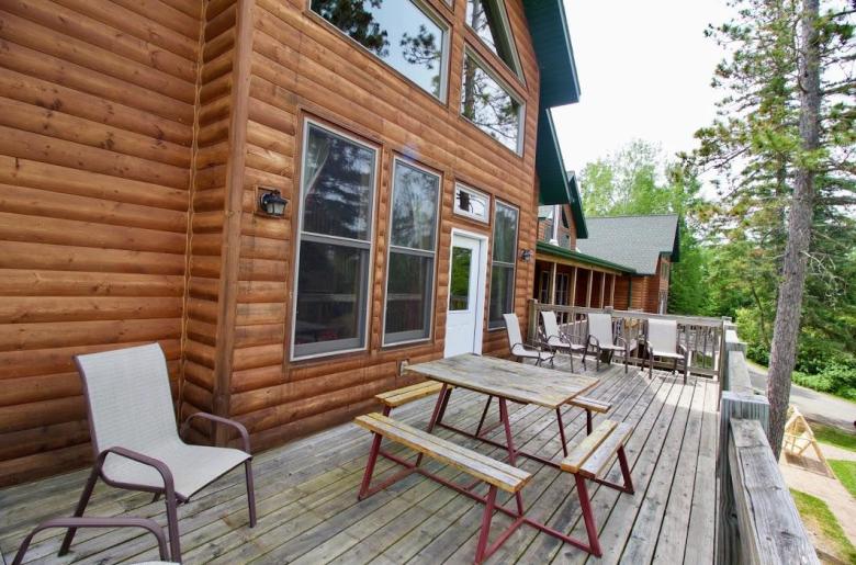 Deck area with seating, picnic table and views of the harbor.