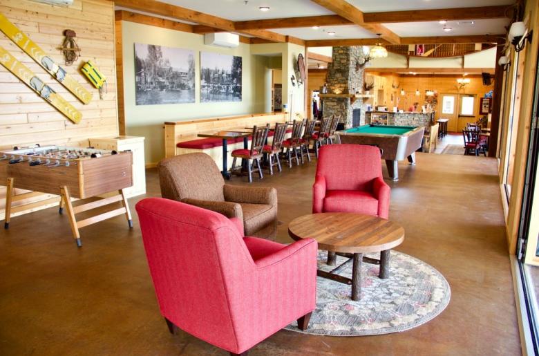 Lodge game area with foosball and pool table.