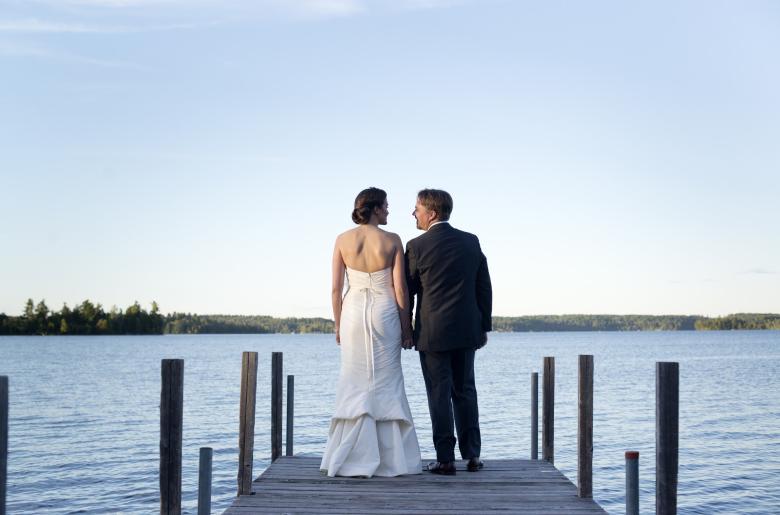 Bride and groom on a dock at Pehrson Lodge