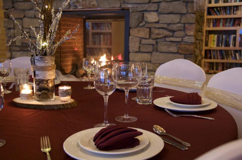 A winter table setting near the fireplace in the Main Lodge