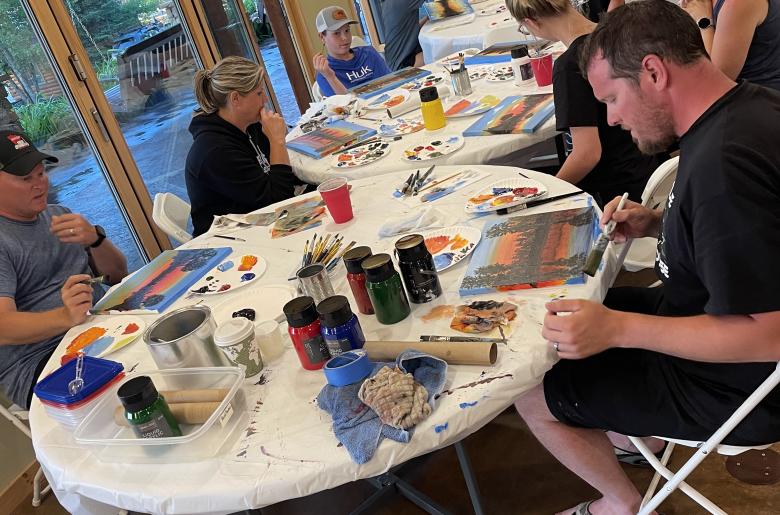 Instructor let painting class in the lodge.