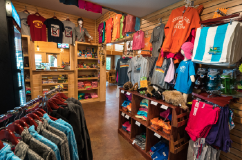 Gift shop with adult, youth, and infant clothing, as well as hats.