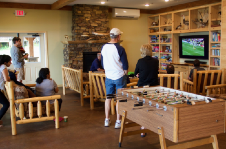 Guests gather around the TV in the Main Lodge.