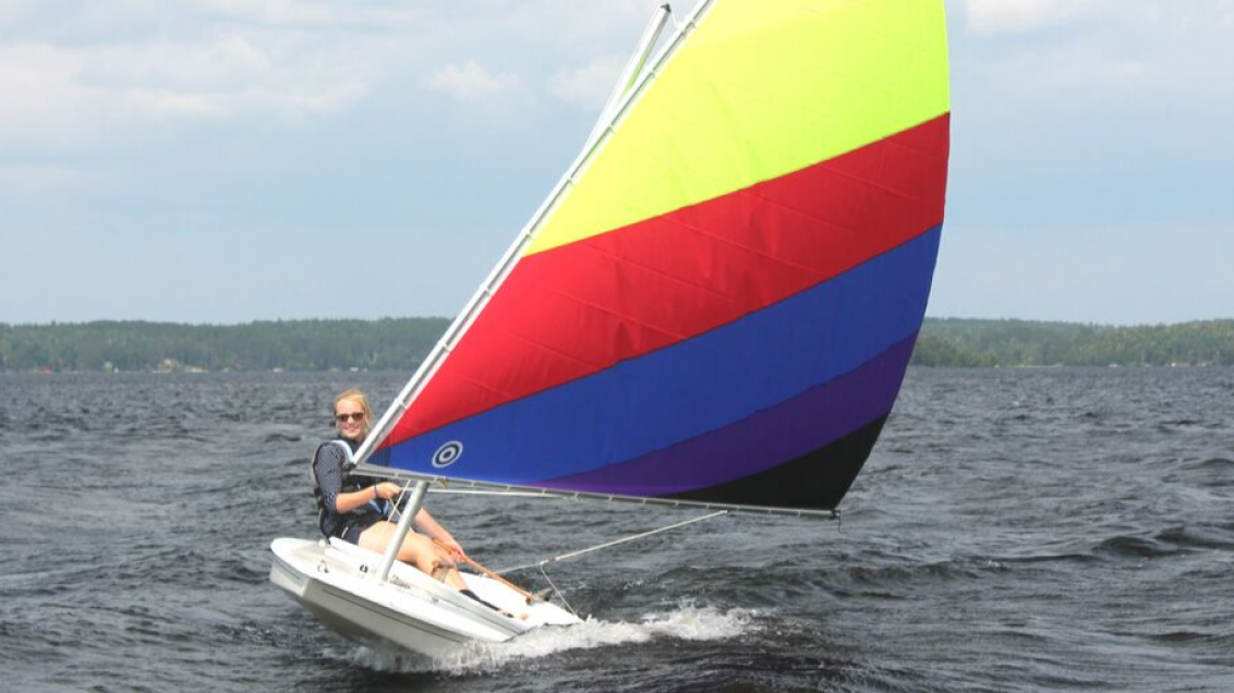 woman on sunfish sailboat