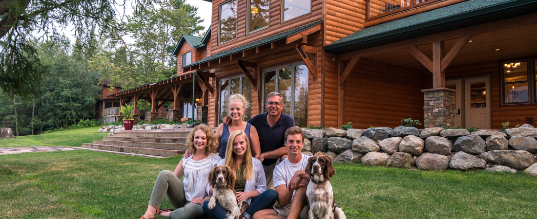 The Hanson Family sitting in front of the Main Lodge