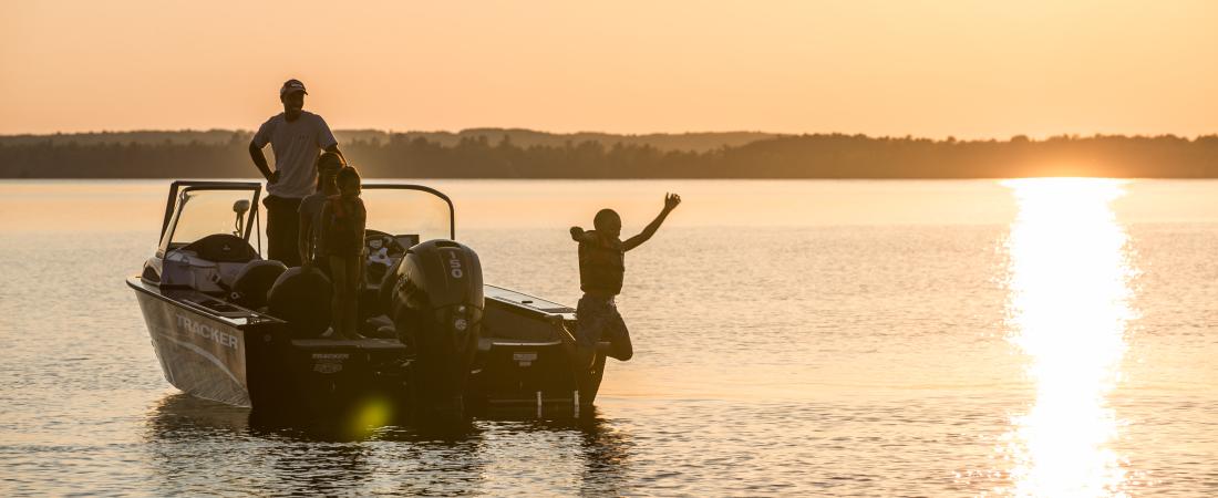 Father and son in boat on Lake Vermilion at sunset. 