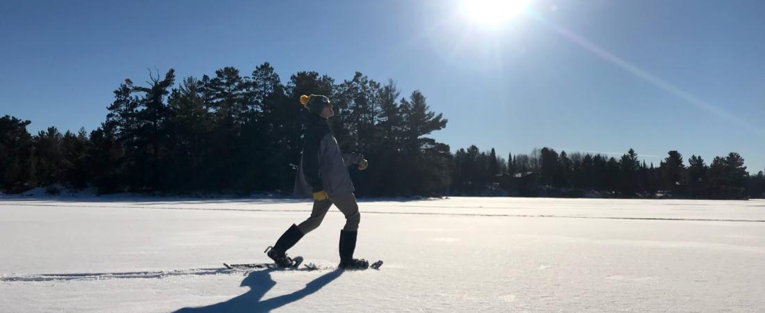 Man snowshoes on Lake Vermilion