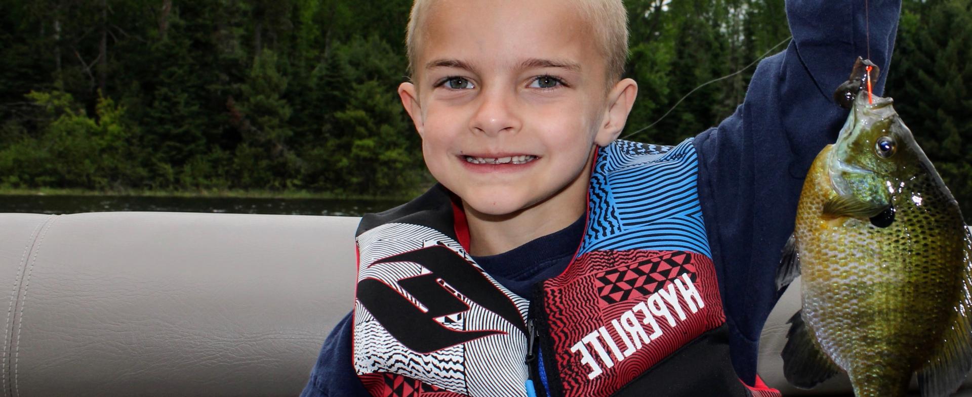Kid holding a blue gill