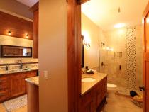 Main floor bathroom with a shower and granite.