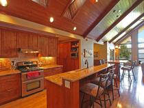 Kitchen with refrigerator, stove, dishwasher, and seating for eight.