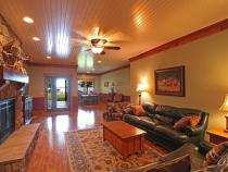 Downstairs living room with plenty of seating, game area, two futons, and gas fireplace.